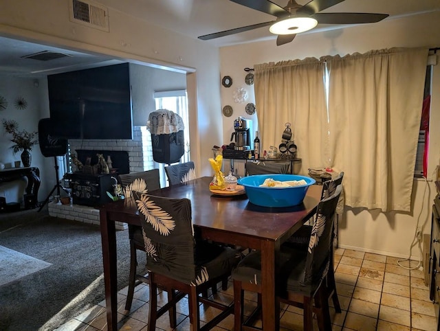 tiled dining space featuring ceiling fan