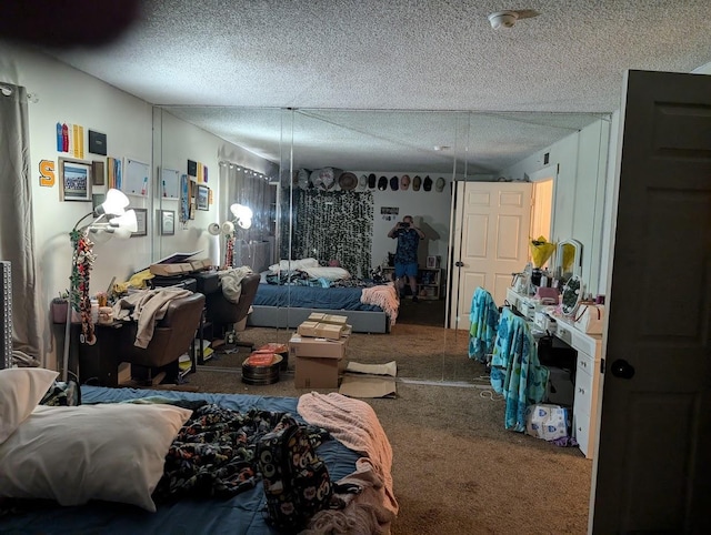 carpeted bedroom featuring a textured ceiling