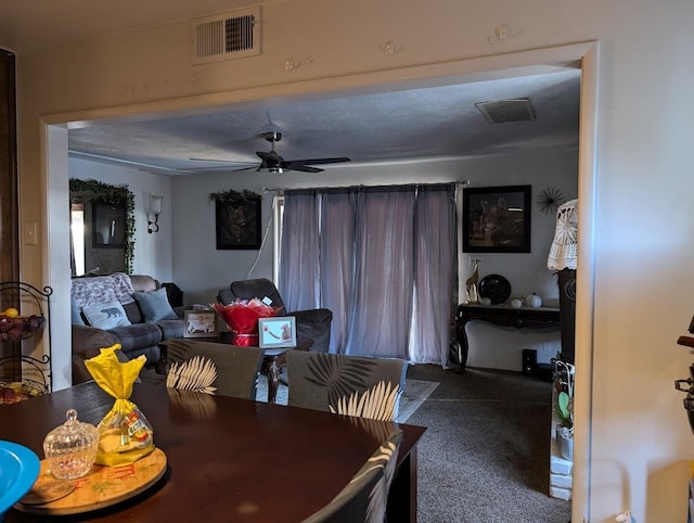 carpeted dining room with ceiling fan