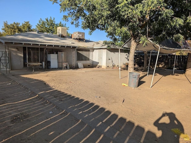 rear view of property featuring a patio area and central AC