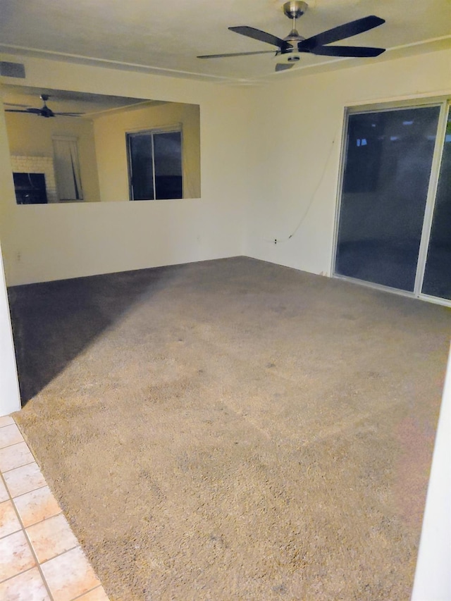 tiled empty room with ceiling fan