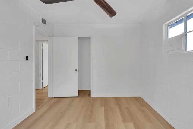 spare room featuring crown molding and light hardwood / wood-style flooring