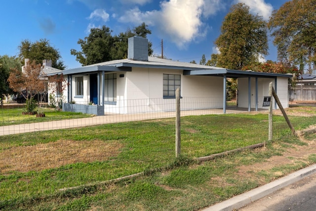 ranch-style home with a front lawn and a carport