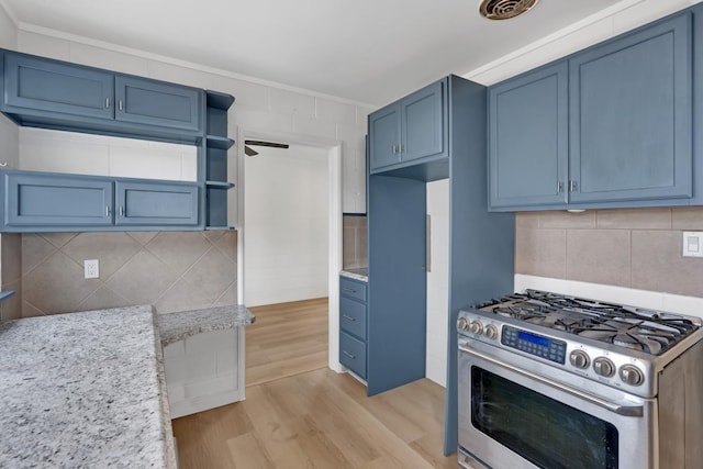 kitchen featuring light hardwood / wood-style floors, gas stove, blue cabinets, and light stone countertops