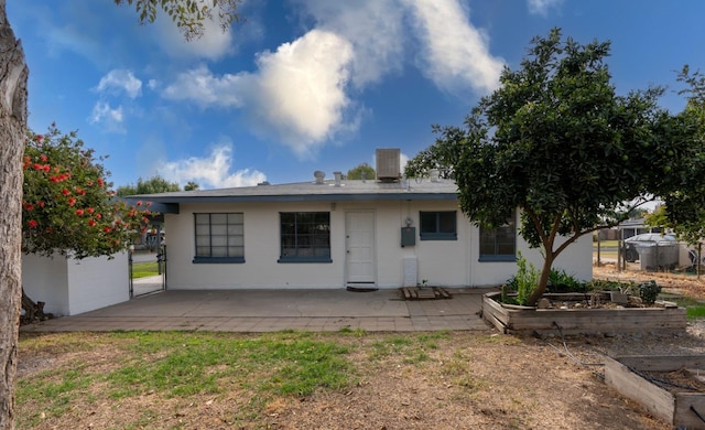 back of house with a patio area and central AC