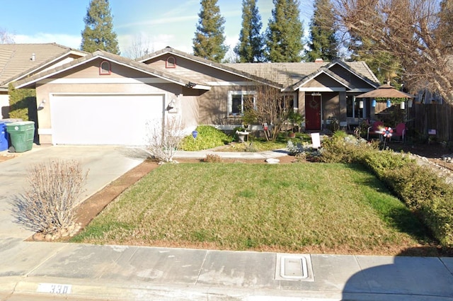 view of front facade with a front yard, a garage, and a gazebo