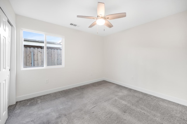 carpeted empty room featuring ceiling fan