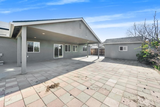 rear view of property with a patio area and an outdoor structure