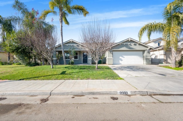 view of front of property with a garage and a front lawn