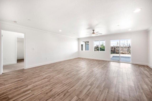 unfurnished room with ceiling fan, light wood-type flooring, and ornamental molding