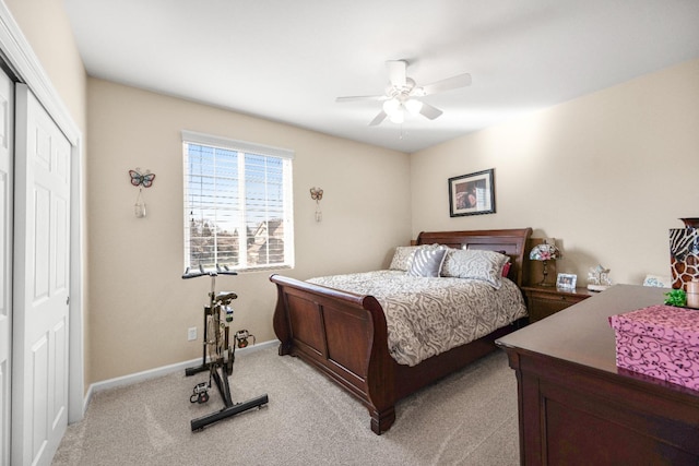 carpeted bedroom featuring ceiling fan and a closet