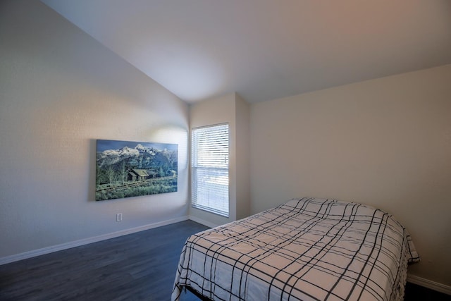 bedroom with dark hardwood / wood-style flooring and lofted ceiling