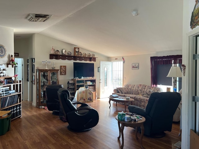 living room featuring vaulted ceiling and hardwood / wood-style floors