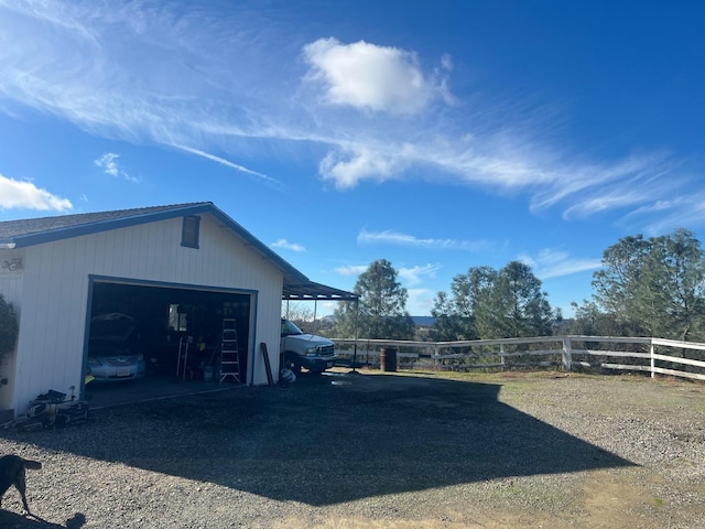 exterior space with a garage and fence