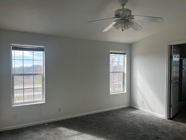 carpeted spare room with a ceiling fan, baseboards, and a healthy amount of sunlight