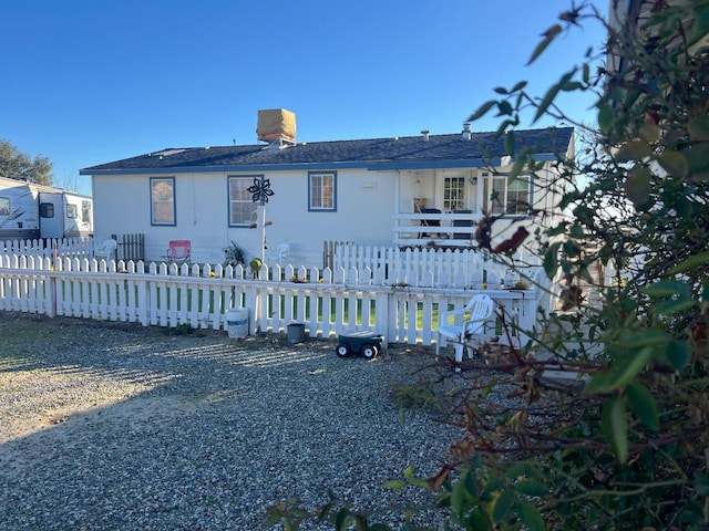 back of property with a fenced front yard