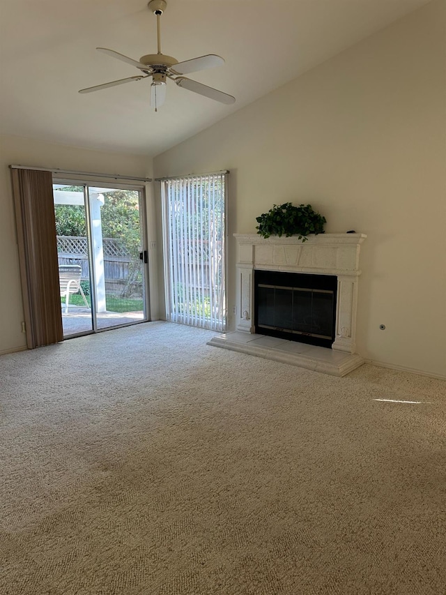 unfurnished living room featuring vaulted ceiling, ceiling fan, and carpet flooring