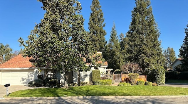 view of front of house with a front yard and a garage