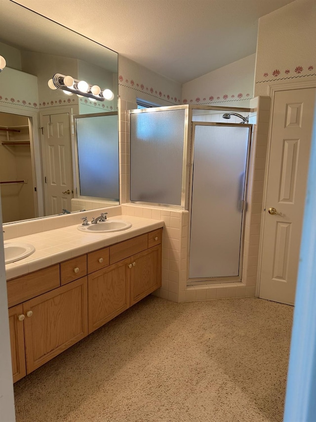 bathroom with walk in shower and vanity