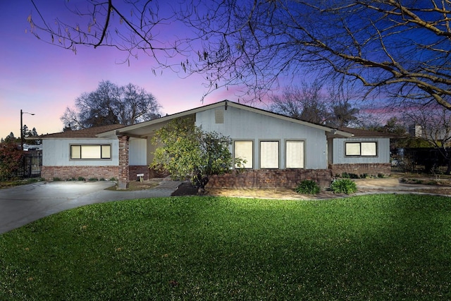 ranch-style house with a lawn