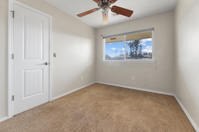 spare room with carpet and ceiling fan