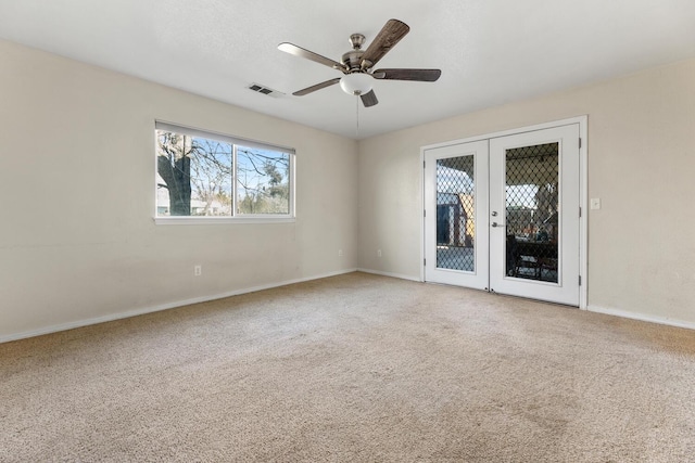 spare room featuring carpet, french doors, and ceiling fan