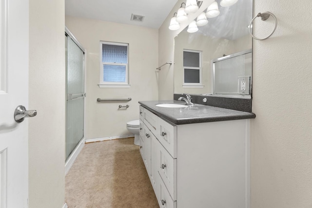 bathroom with walk in shower, vanity, and toilet