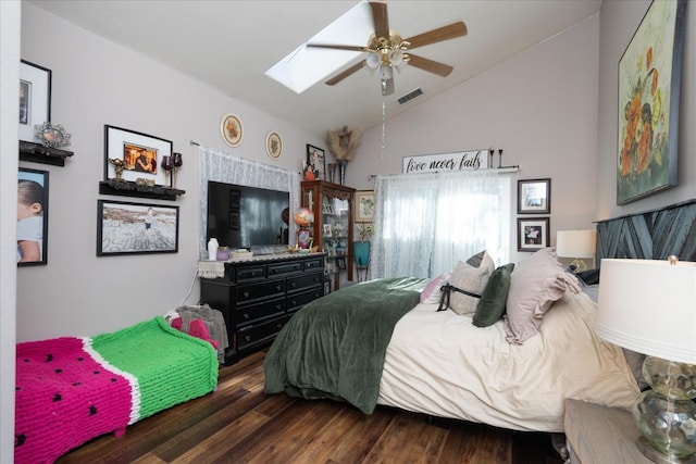 bedroom with ceiling fan, dark wood-type flooring, high vaulted ceiling, and a skylight