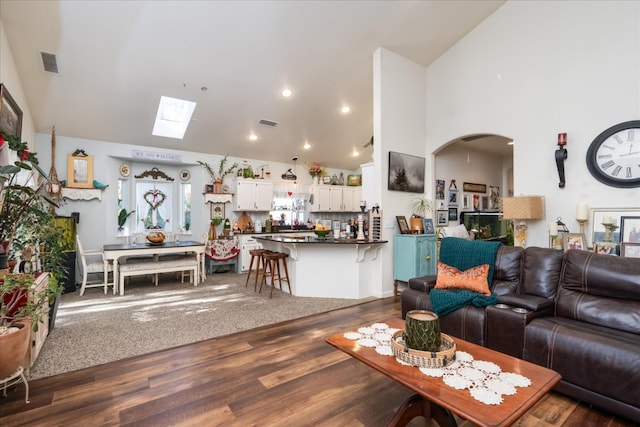 living room featuring vaulted ceiling and dark hardwood / wood-style flooring