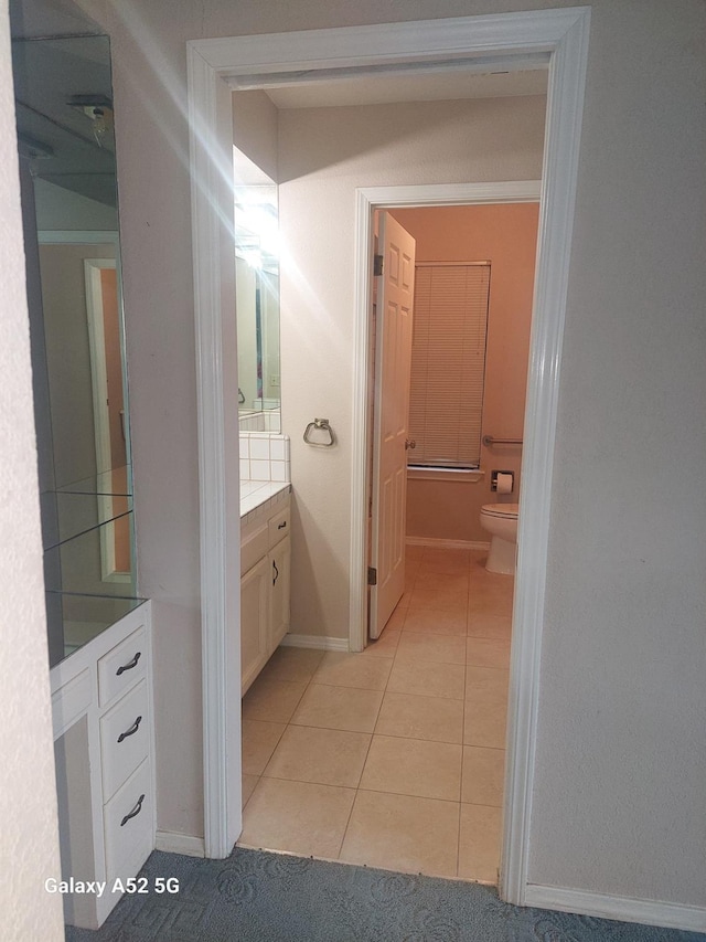 bathroom featuring tile patterned floors, vanity, and toilet