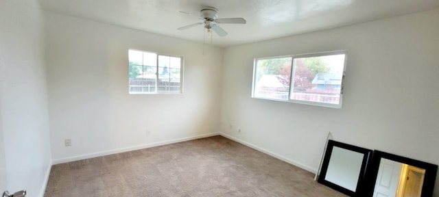 carpeted spare room with ceiling fan and a healthy amount of sunlight