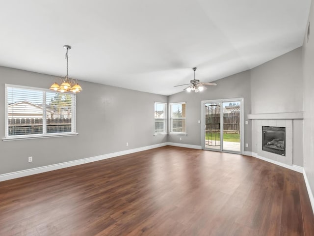 unfurnished living room with a fireplace, dark hardwood / wood-style flooring, ceiling fan with notable chandelier, and lofted ceiling