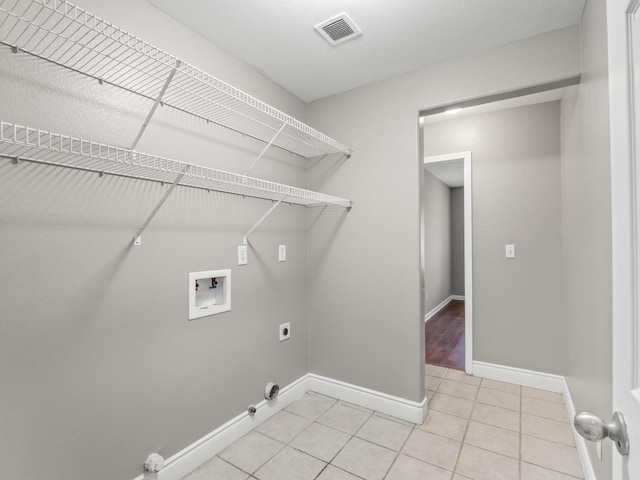 laundry area with tile patterned flooring, washer hookup, gas dryer hookup, and electric dryer hookup