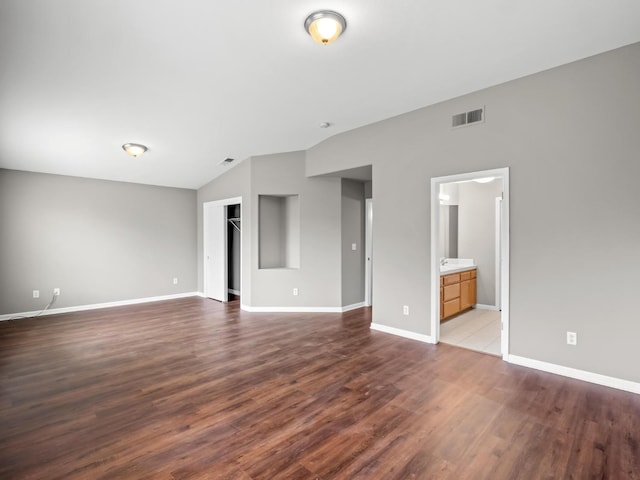 interior space featuring dark hardwood / wood-style floors and lofted ceiling