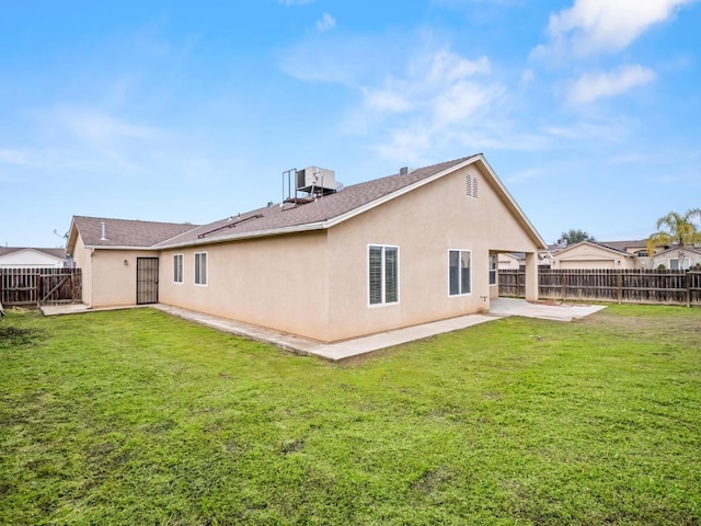 rear view of property with a patio and a yard