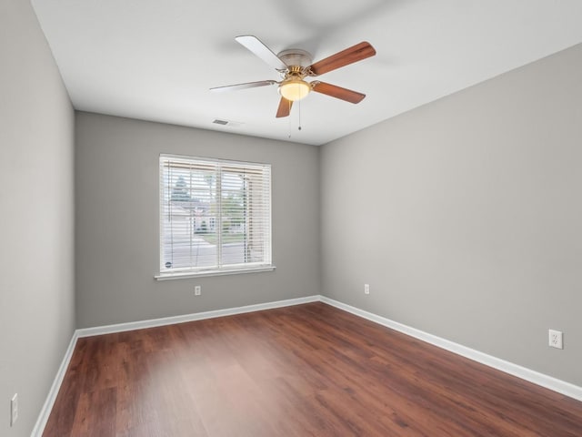 unfurnished room featuring ceiling fan and dark hardwood / wood-style floors