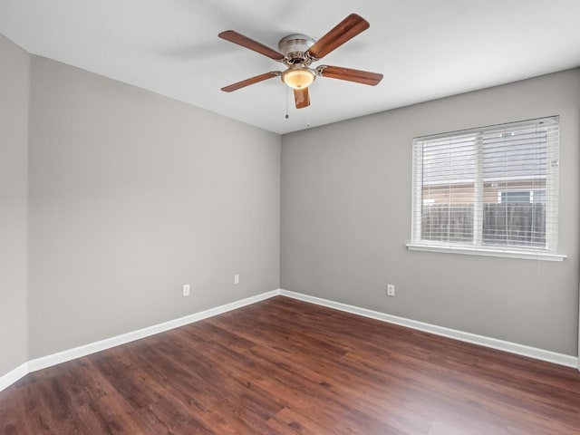 unfurnished room with dark hardwood / wood-style flooring and ceiling fan