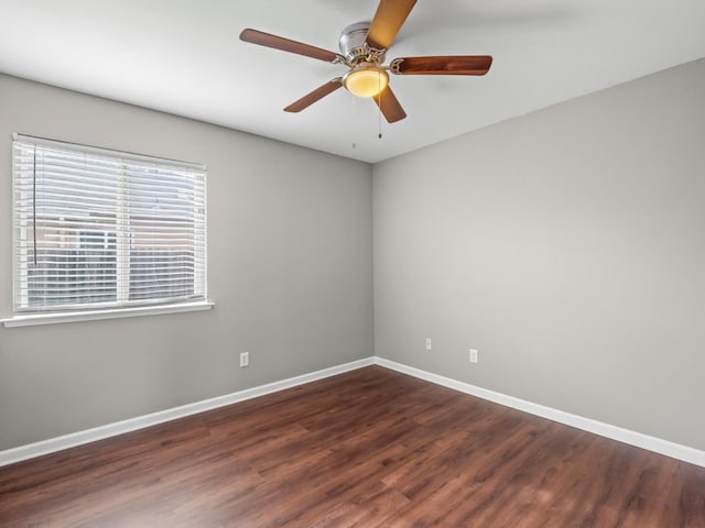 unfurnished room with ceiling fan and dark hardwood / wood-style floors