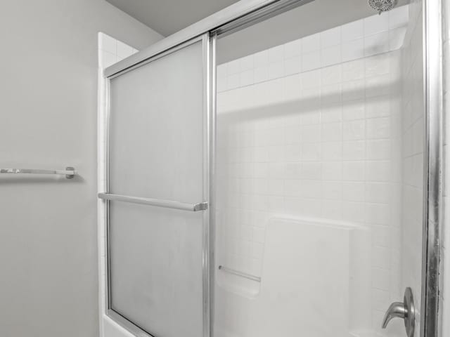 bathroom with shower / bath combination with glass door