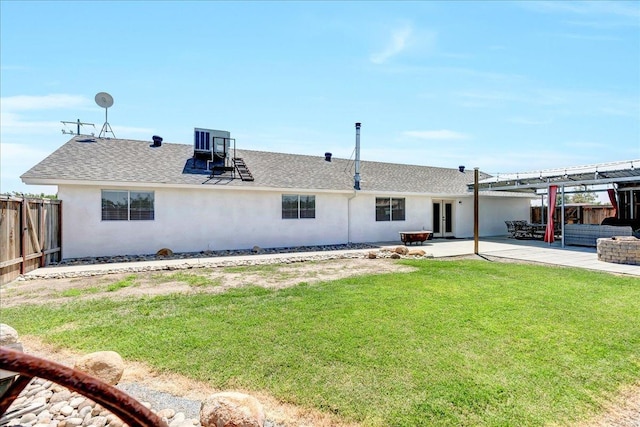 back of property with a lawn, cooling unit, and a patio area