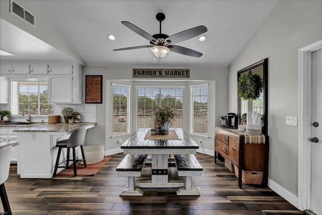 dining space with a wealth of natural light, dark hardwood / wood-style floors, and lofted ceiling