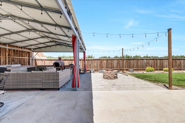 view of patio featuring an outdoor living space with a fire pit