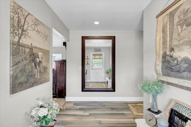 hallway with hardwood / wood-style floors