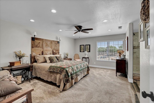 carpeted bedroom featuring ceiling fan and a textured ceiling