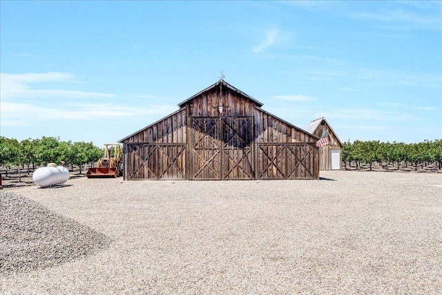 view of outbuilding featuring a rural view and a garage