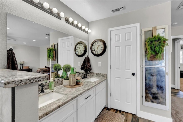 bathroom with wood-type flooring and vanity