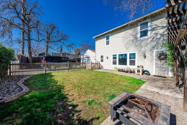 rear view of property with an outdoor fire pit, a fenced backyard, a lawn, and a patio