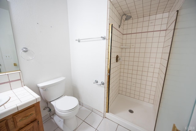 bathroom with toilet, tile patterned floors, a shower stall, and vanity