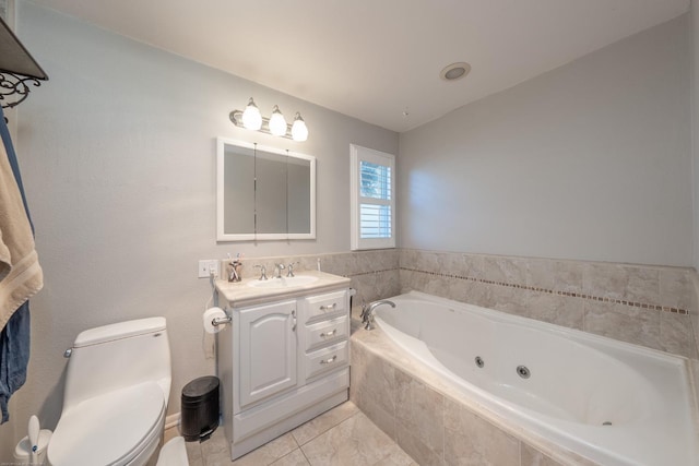 bathroom featuring toilet, a whirlpool tub, vanity, and tile patterned floors