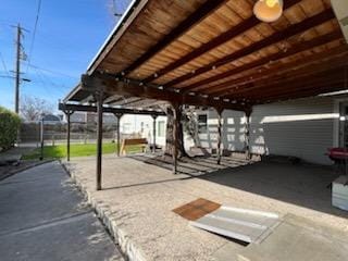 view of vehicle parking with a carport